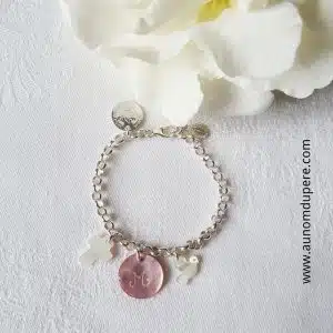 Bracelet sur chaîne avec une mini croix, une mini médaille en nacre et une mini colombe